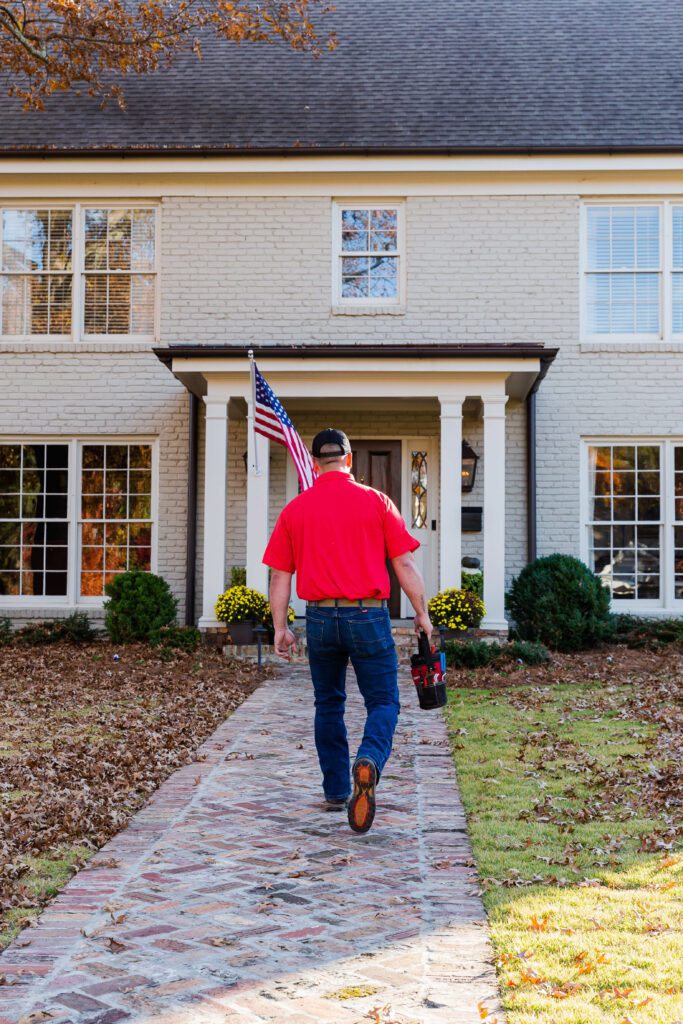 Worker in front of home.