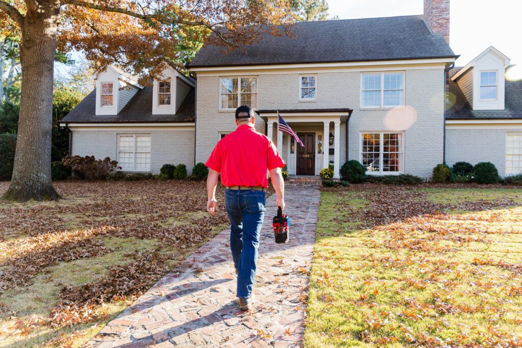 A Plumber in Huntsville, Alabama from Blake Brothers Walking Up to a Customer Home