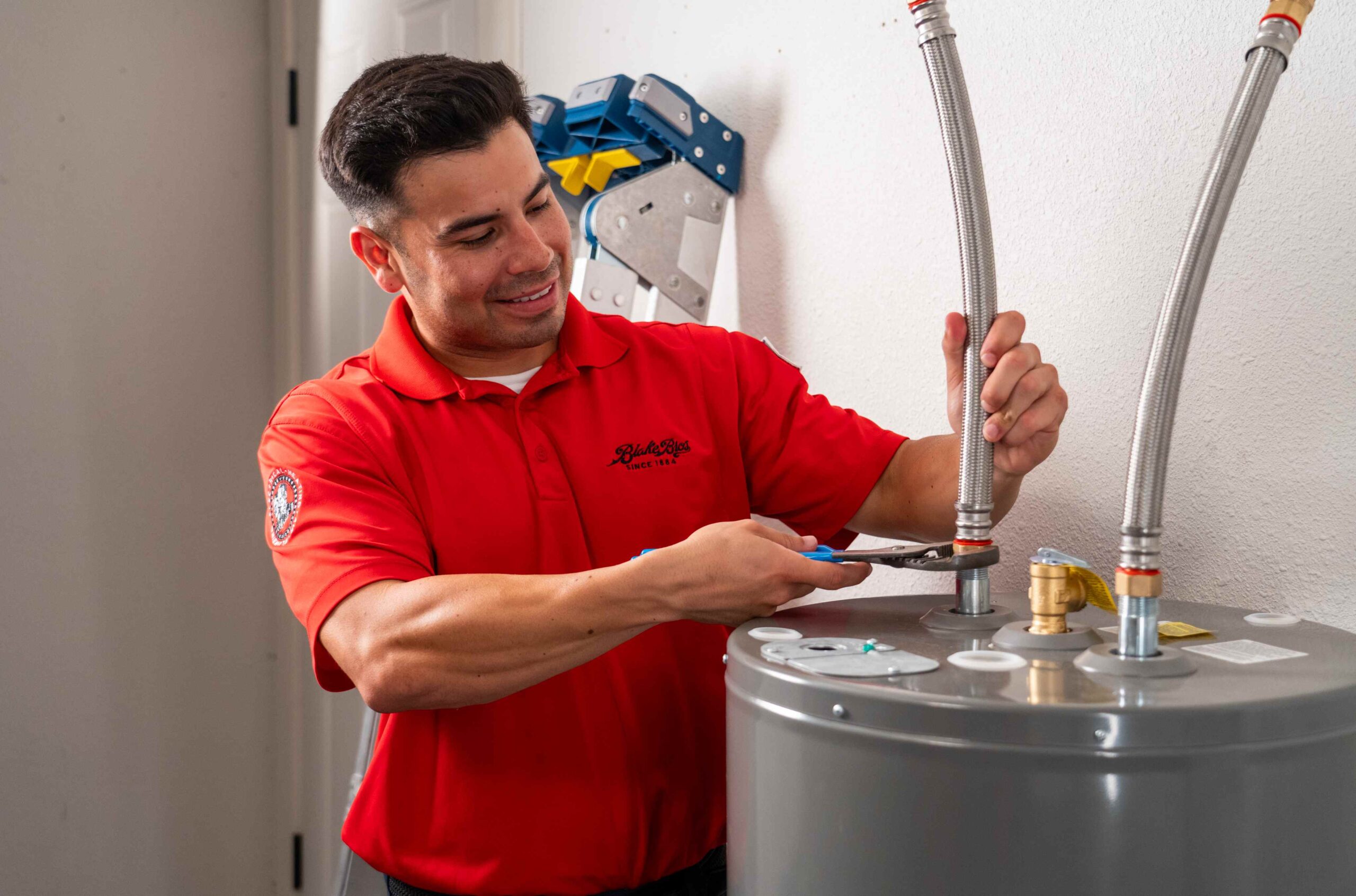 Plumber Fixing a Water Heater Tank